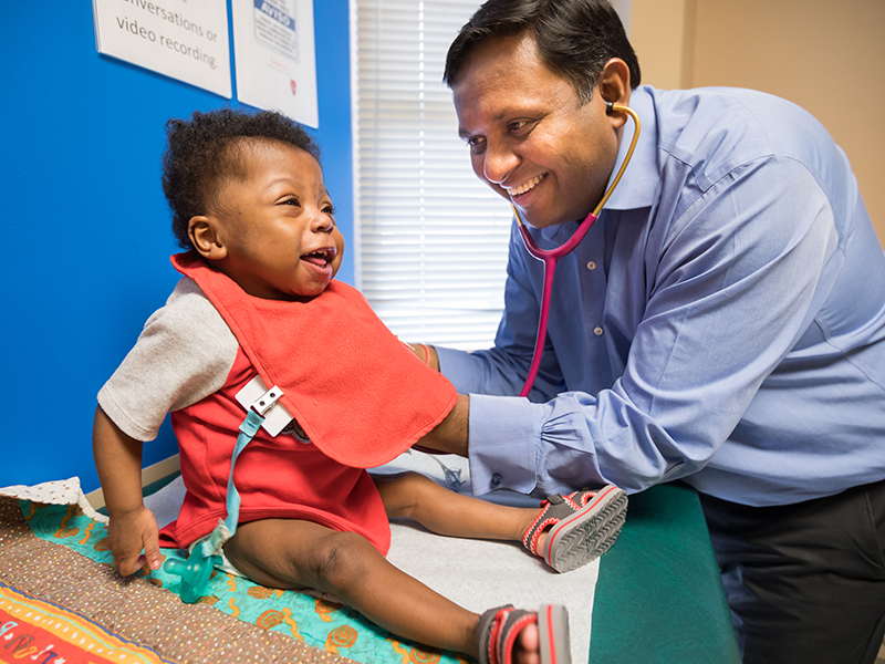 Jharad Faust laughs during a check-up with his pediatric cardiologist, Dr. Avichal Aggarwal.